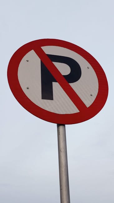 A green and white urban parking restriction sign mounted on a metal pole, indicating a two-hour parking limit from 8 am to 8 pm, Monday to Saturday, with exceptions on Sundays. The sign is outdoors, s